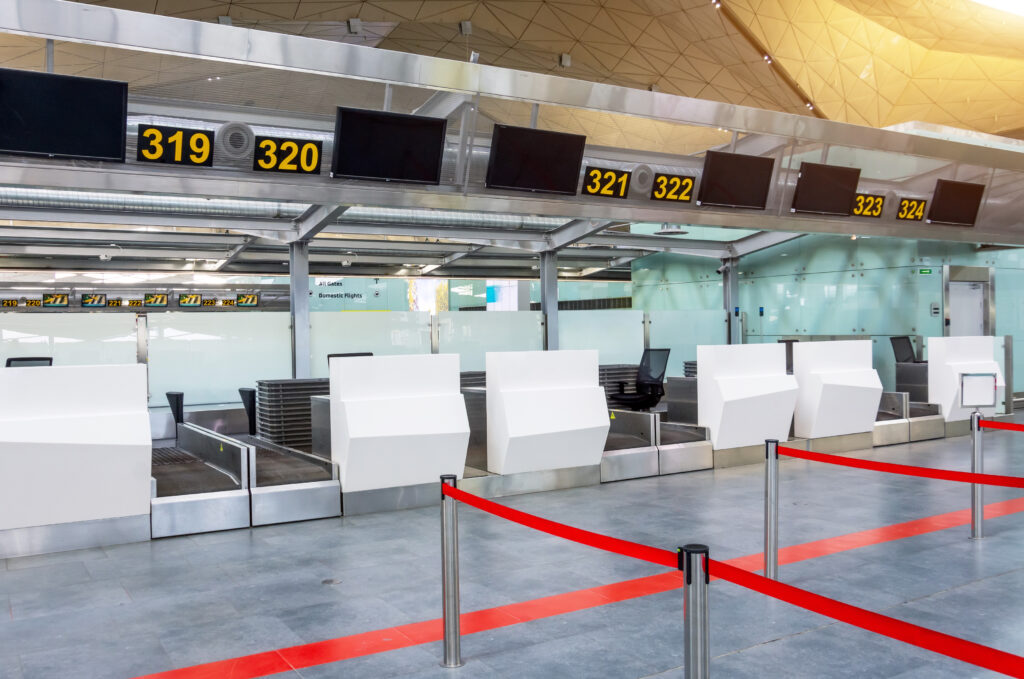 empty-check-desks-drop-off-baggage-with-paths-canceled-with-red-ribbon-differentiate-passengers-airport-terminal-07